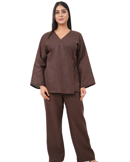 A woman wearing a chocolate brown linen co-ord set on a white background