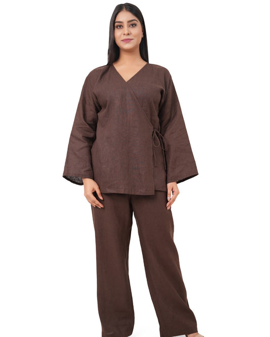 A woman wearing a chocolate brown linen co-ord set on a white background