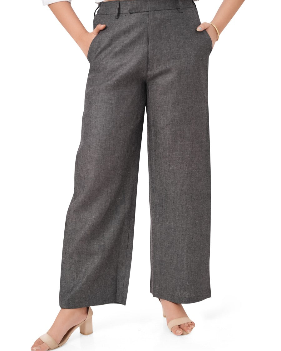 charcoal black linen pants worn by a person on a white background