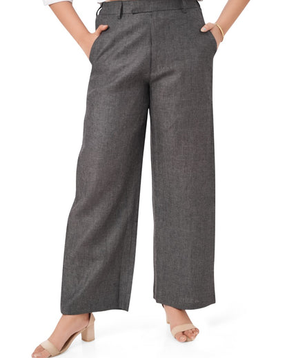 charcoal black linen pants worn by a person on a white background