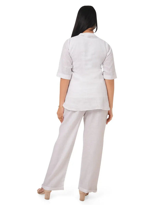 Woman wearing a white top and light gray pants on a white background