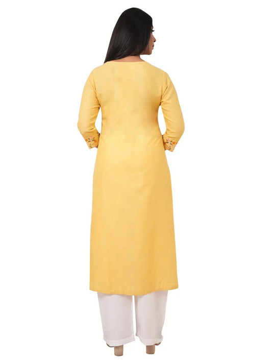 A woman wearing a yellow linen kurti with white pants on a white background