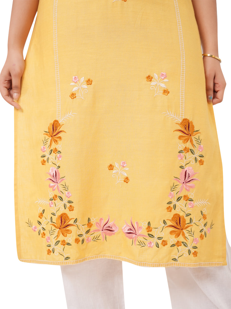 yellow linen kurti with floral embroidery on a white background